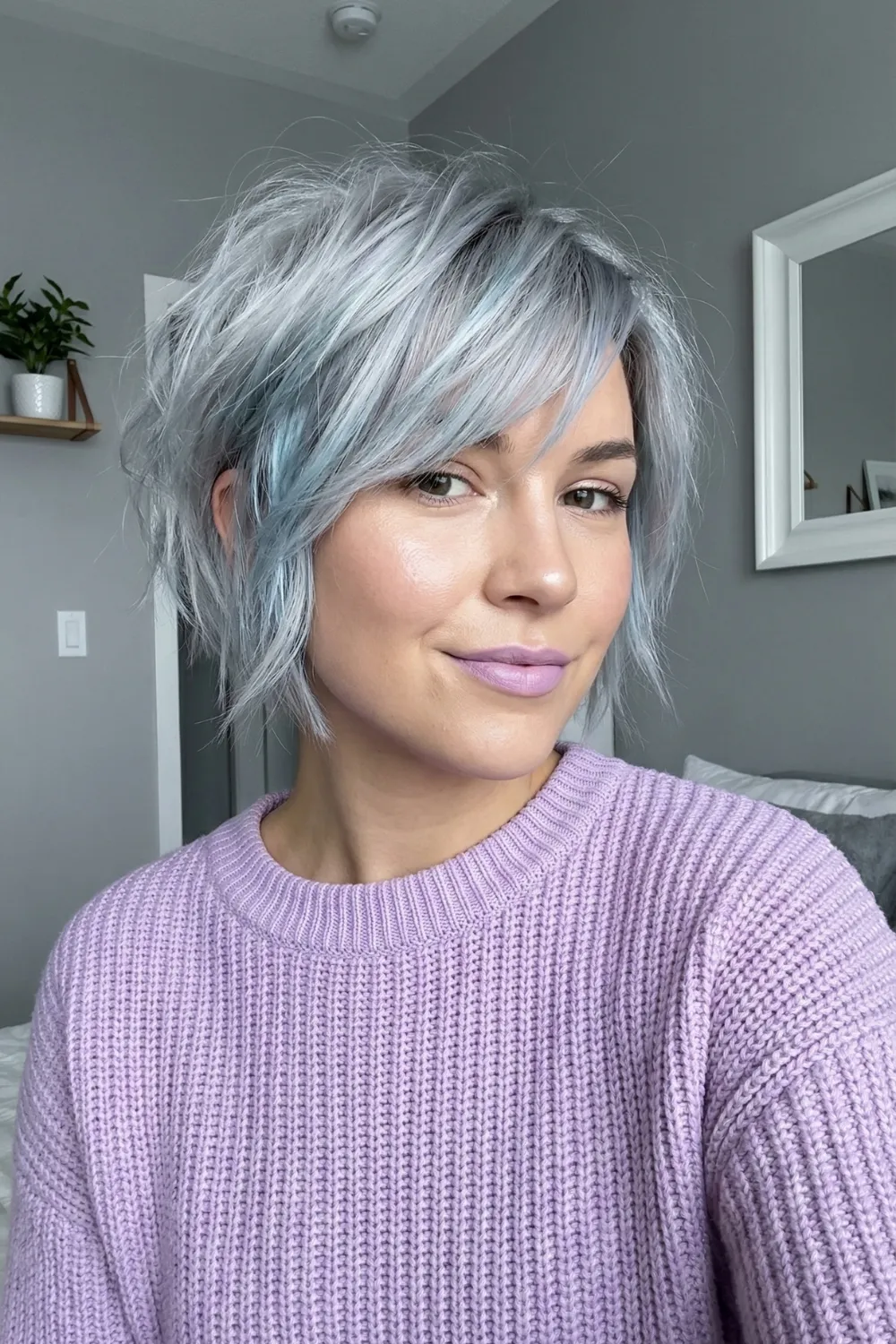 Woman with silver grey choppy pixie bob hybrid and side swept bangs