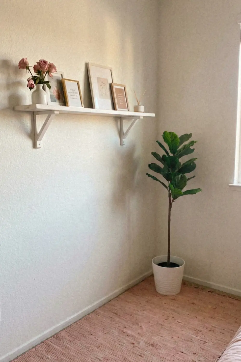 Feminine empty corner decor with floating shelf pink roses and fiddle leaf fig tree