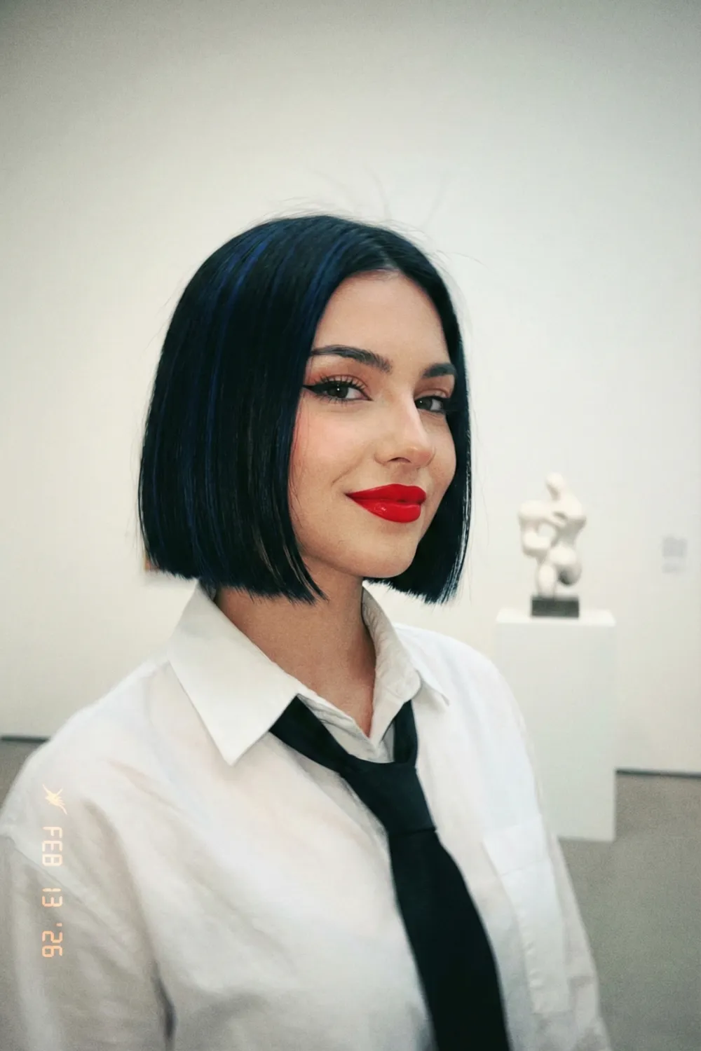 Woman with jet black sleek micro bob and sharp blunt edges