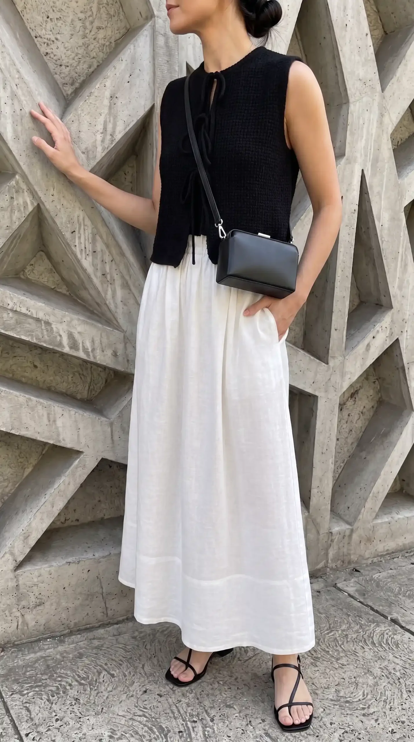 women in black top white maxi skirt