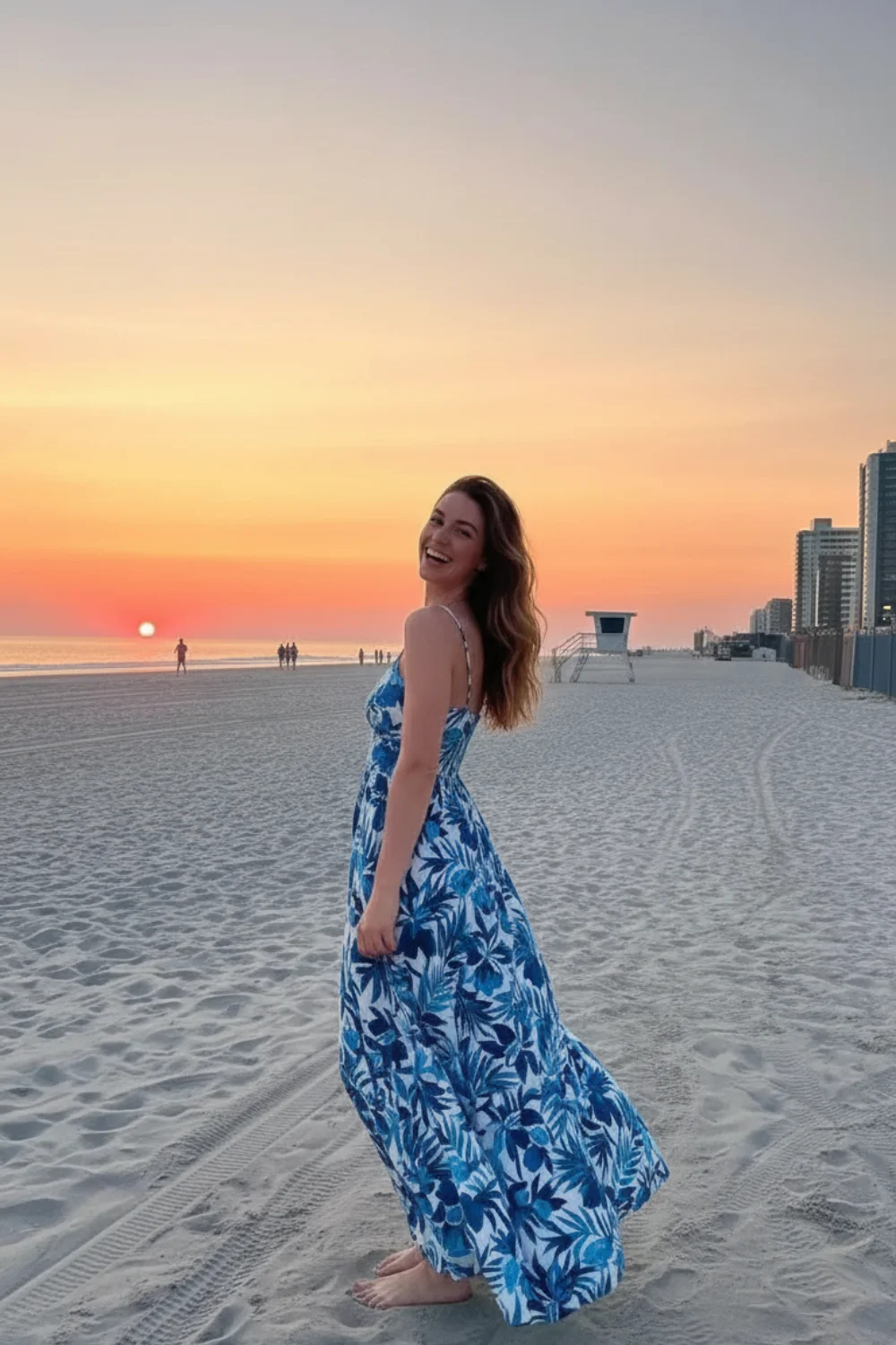 oman wearing blue and white tropical palm print maxi dress at beach during sunset