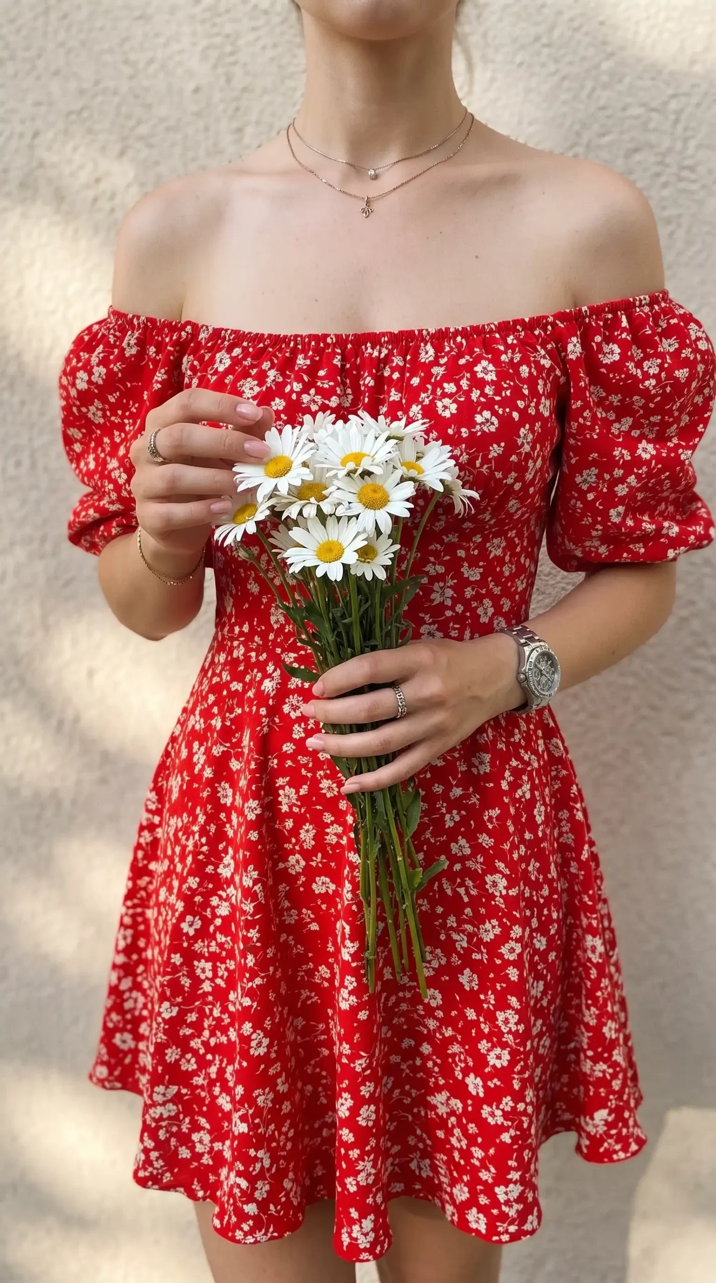 Woman wearing red floral off-shoulder mini dress with puff sleeves