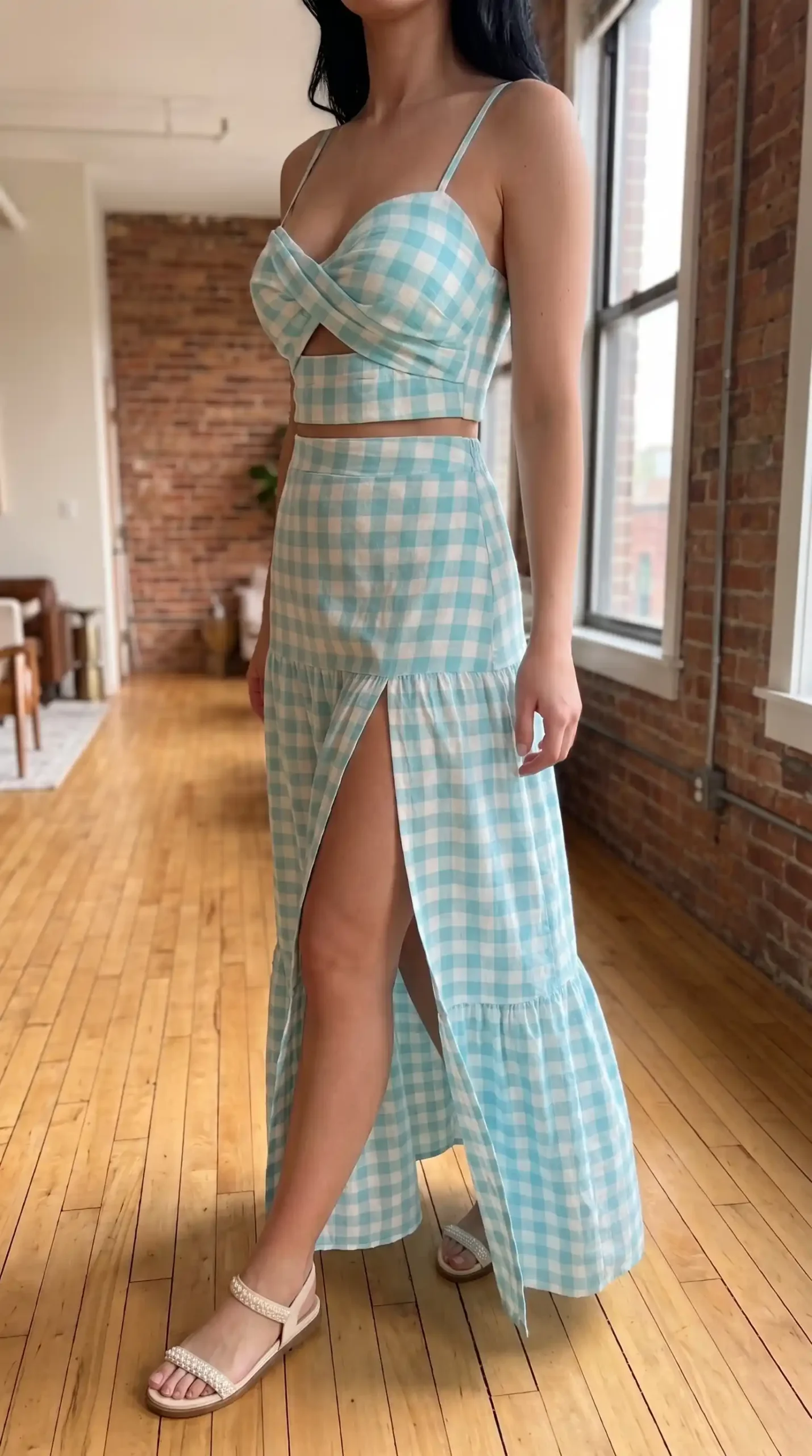 Woman wearing turquoise gingham wrap crop top and tiered thigh slit maxi skirt co-ord