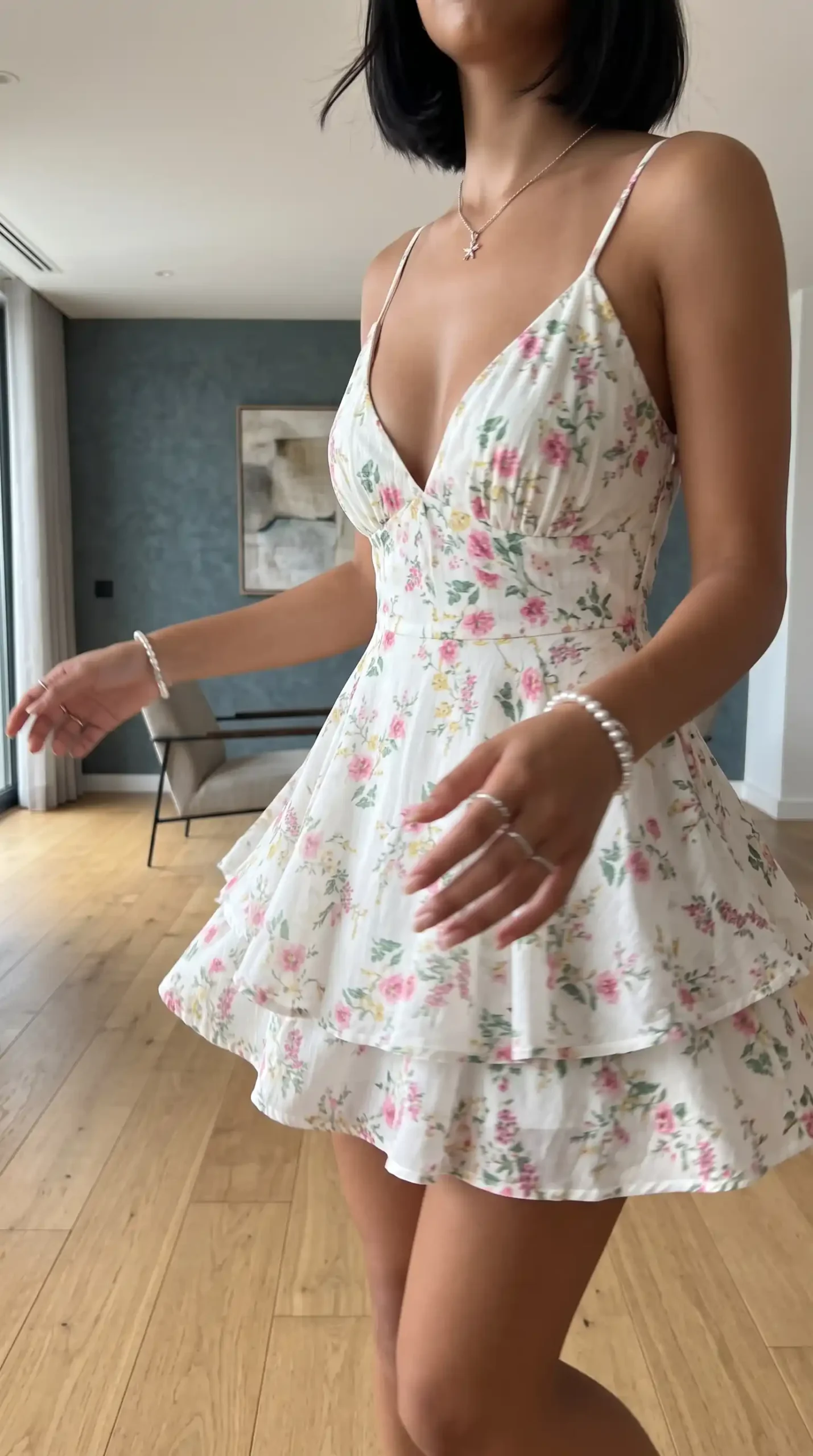 Woman wearing white pink floral deep v neck ruffle tier mini dress