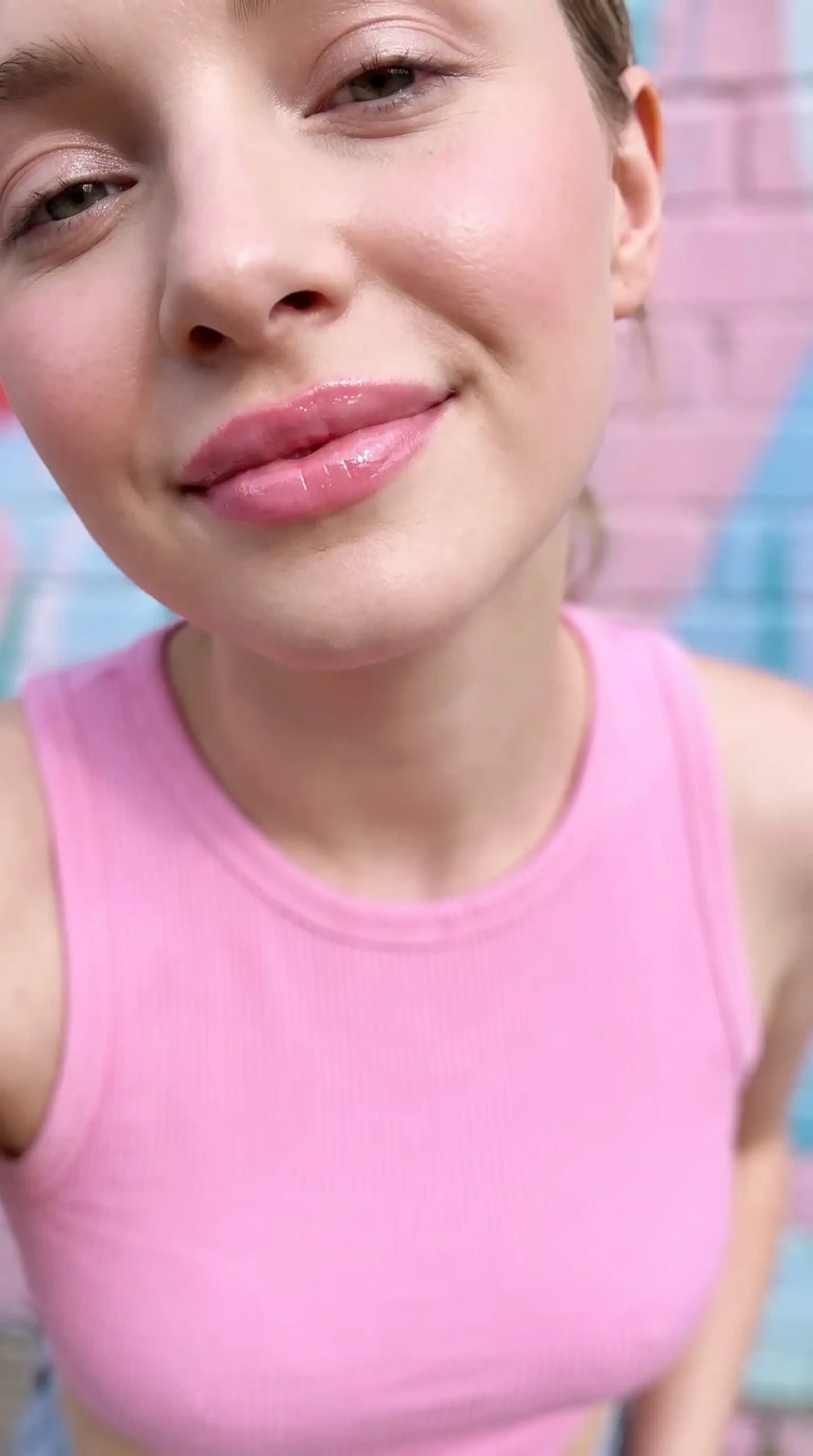 Woman wearing cotton candy bright sweet pink glossy wet lipstick