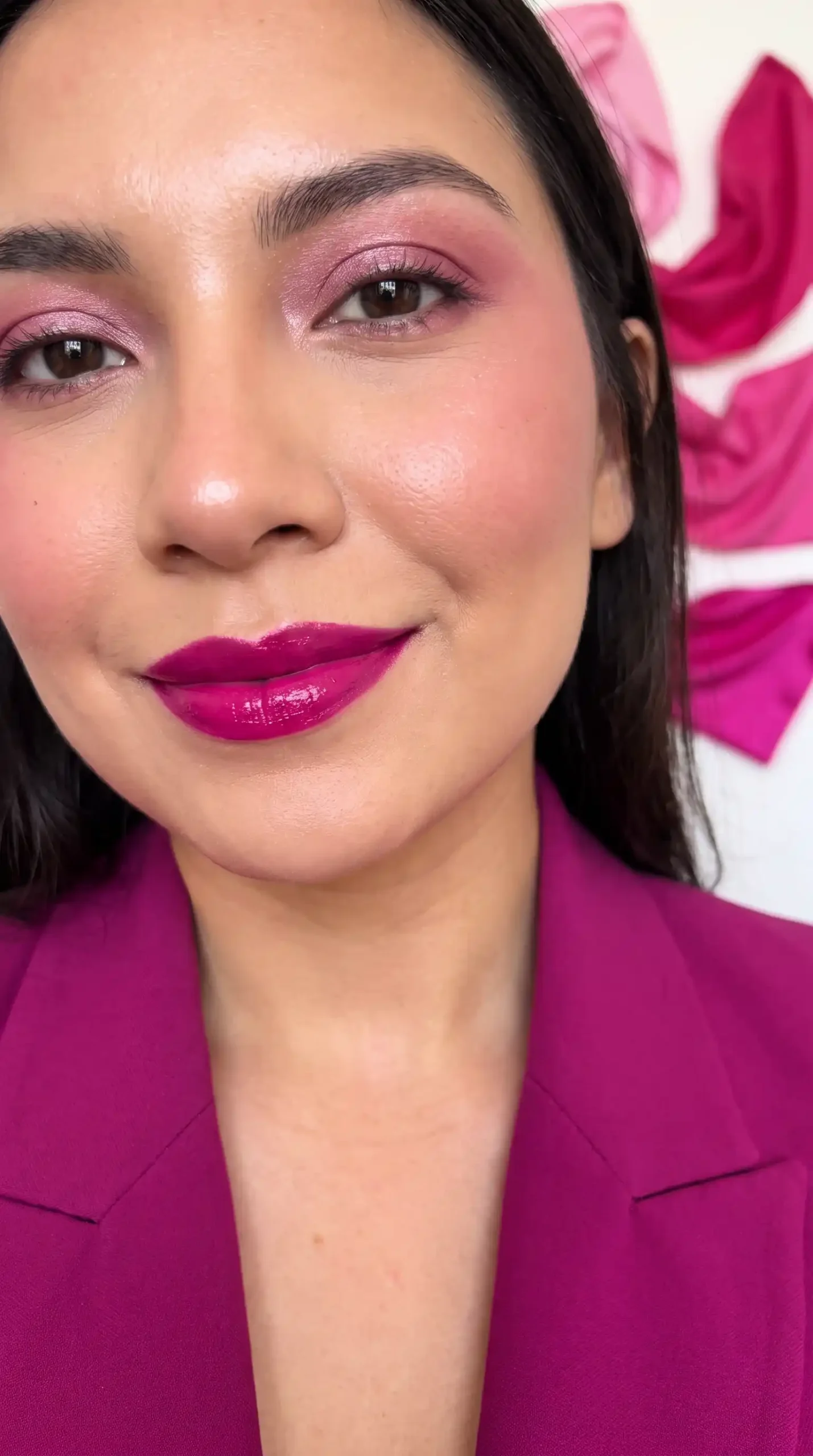 Woman wearing magenta pink vibrant hot glossy wet lipstick with bold makeup