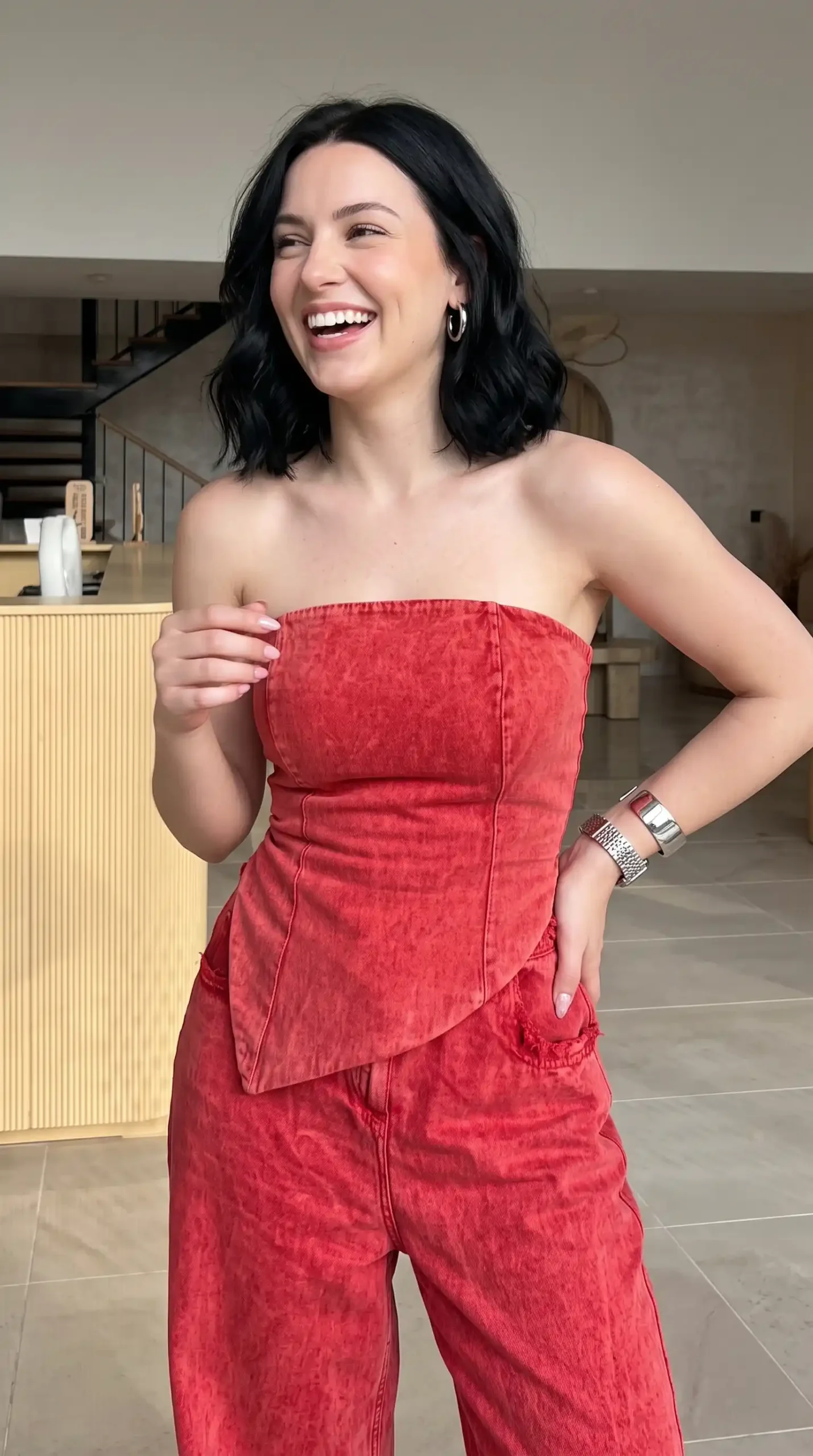 Woman laughing in red acid wash strapless top and matching pants