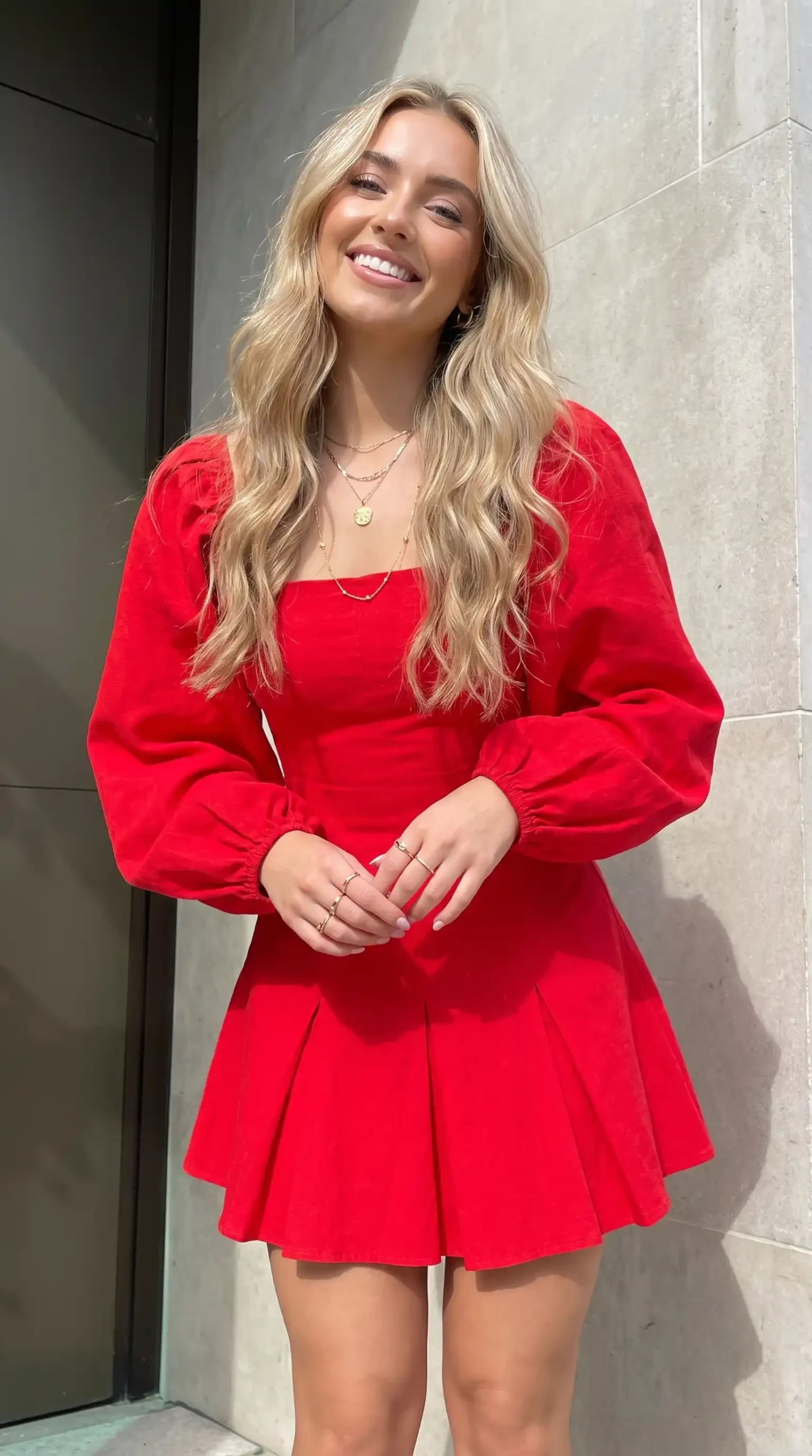Woman wearing red square neck balloon sleeve pleated mini dress