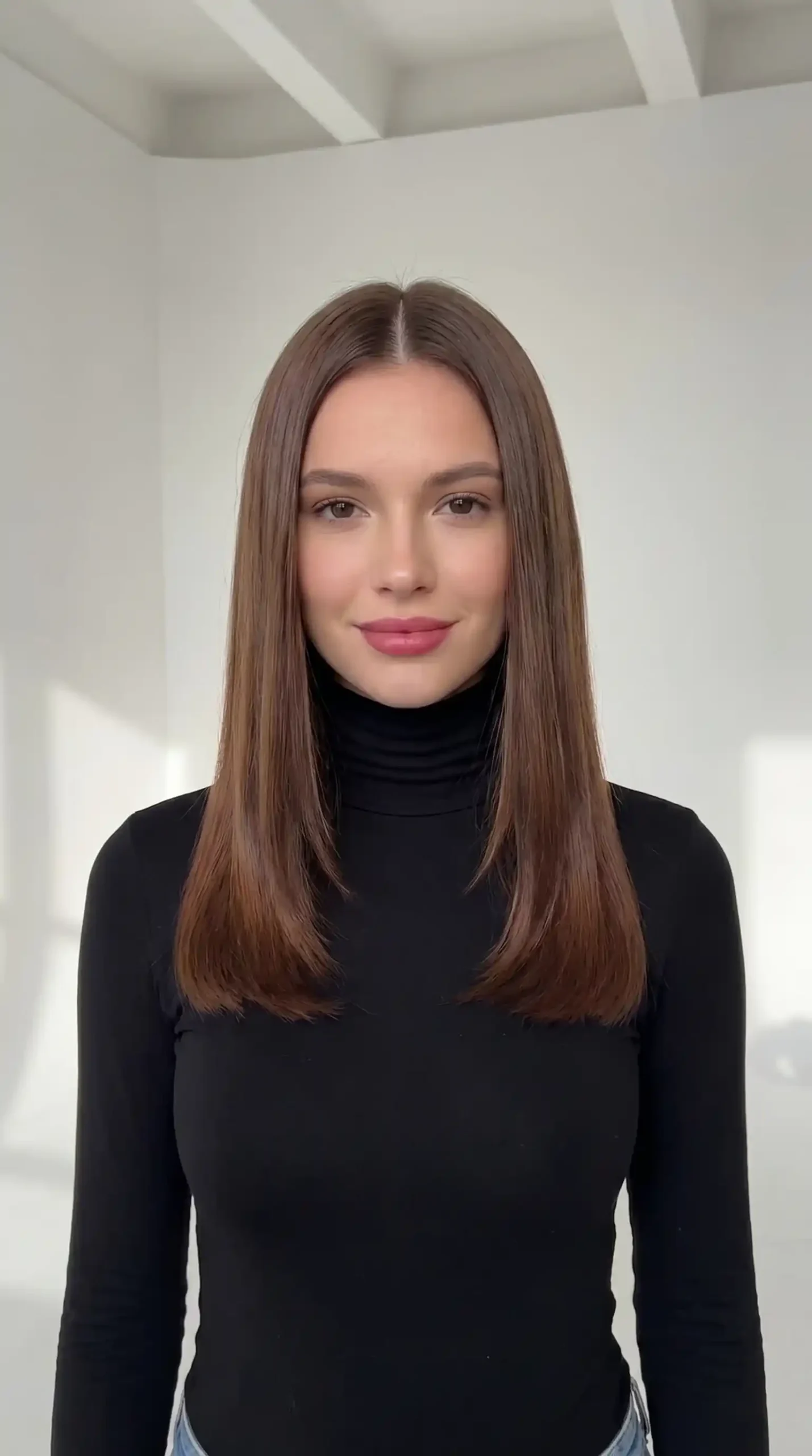 Woman with glossy chestnut brown sleek middle part straight hair