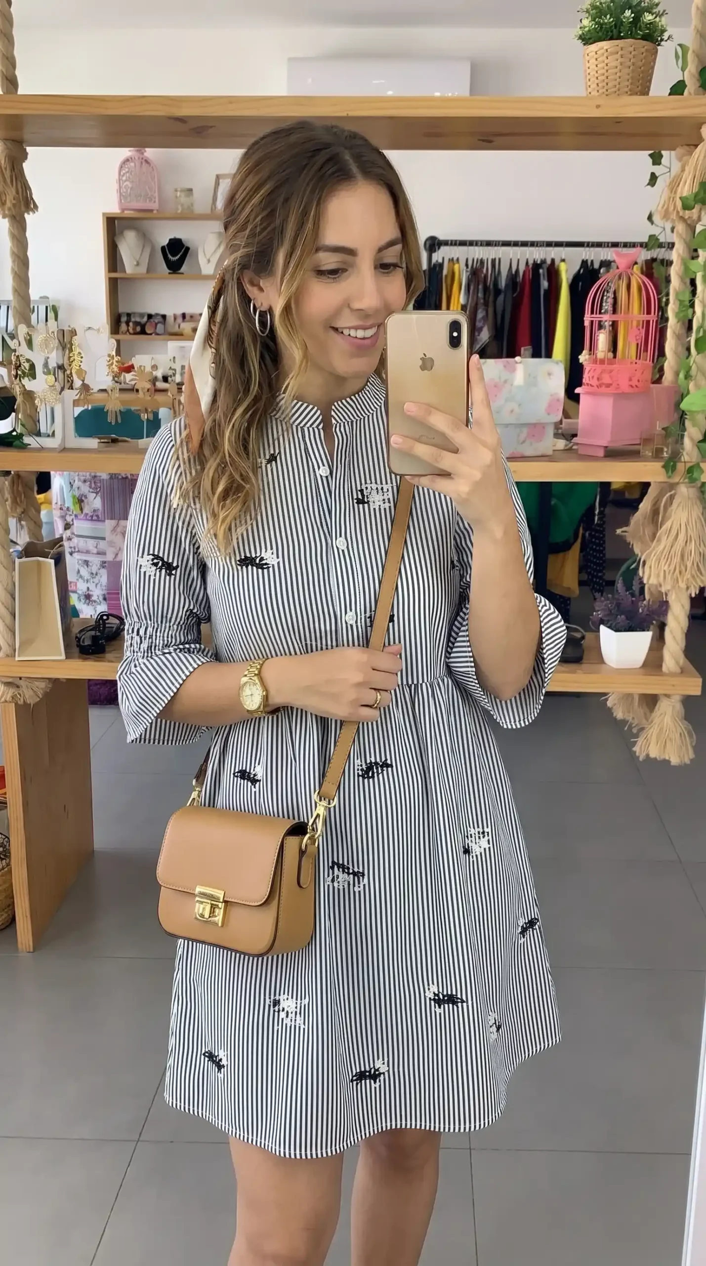Woman wearing white and black striped shirt dress with embroidered details