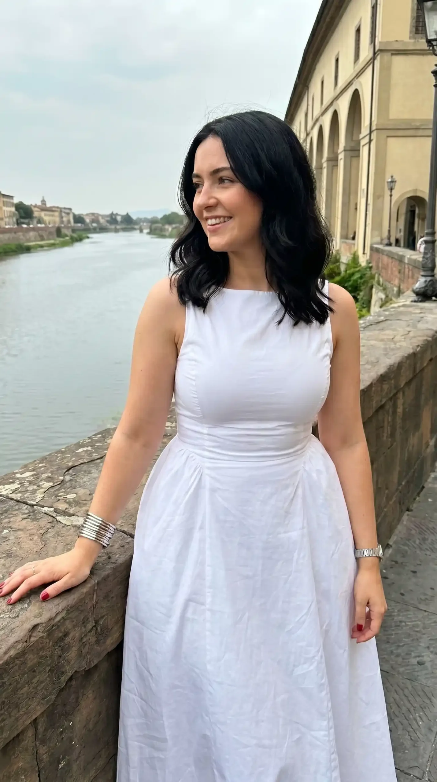 Woman wearing white sleeveless boat neck A line midi dress by riverside in summer