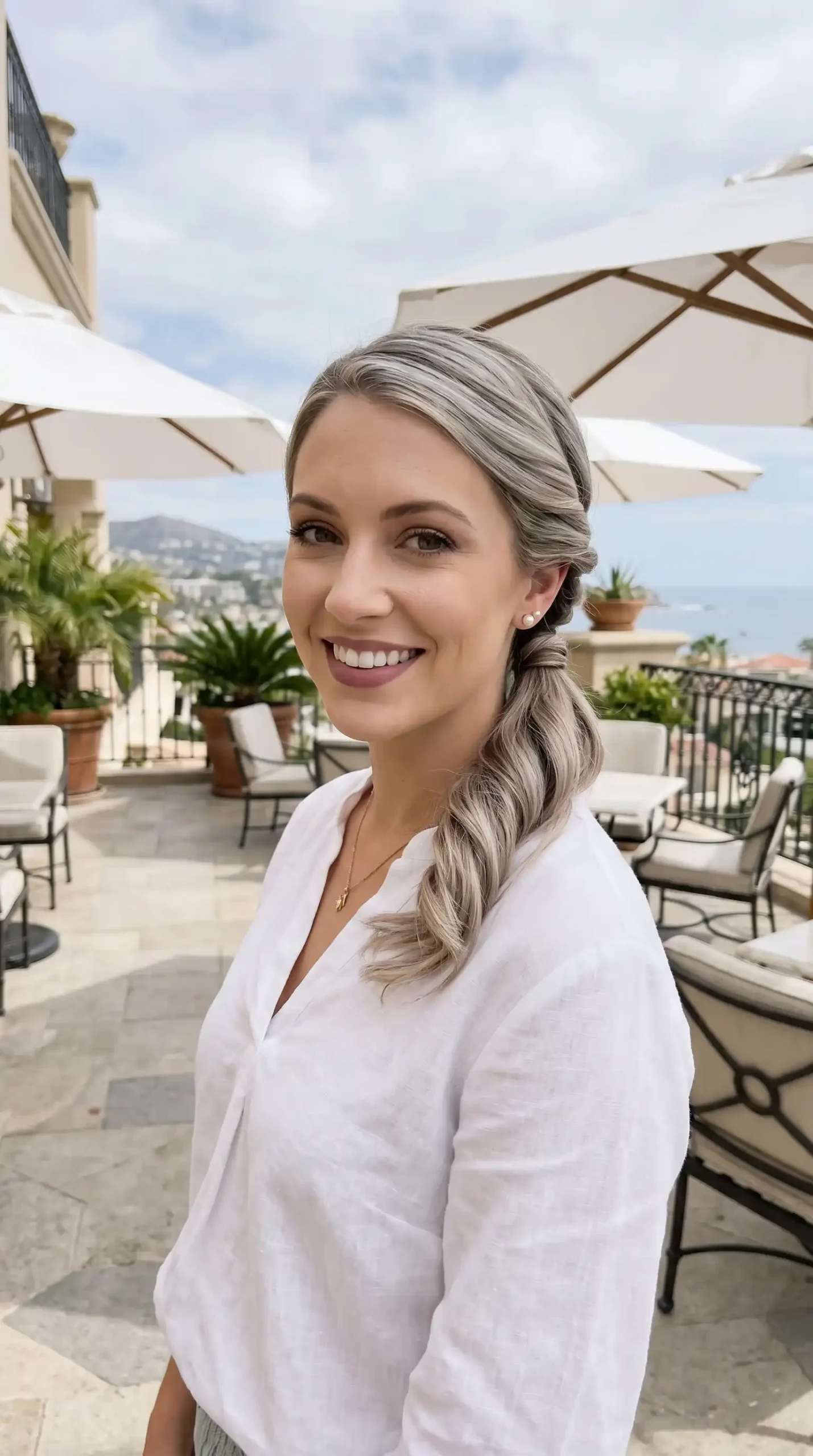 Woman with ash blonde twisted low ponytail hairstyle