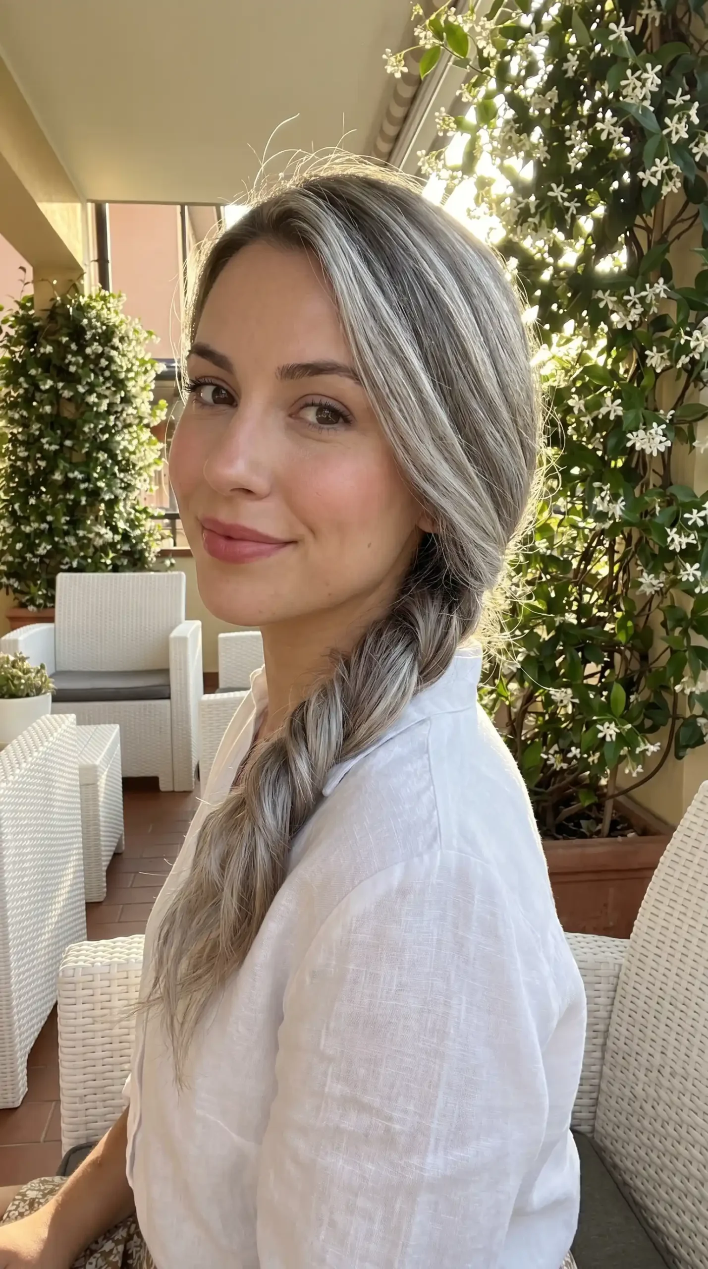 Woman with ash blonde twisted side ponytail hairstyle