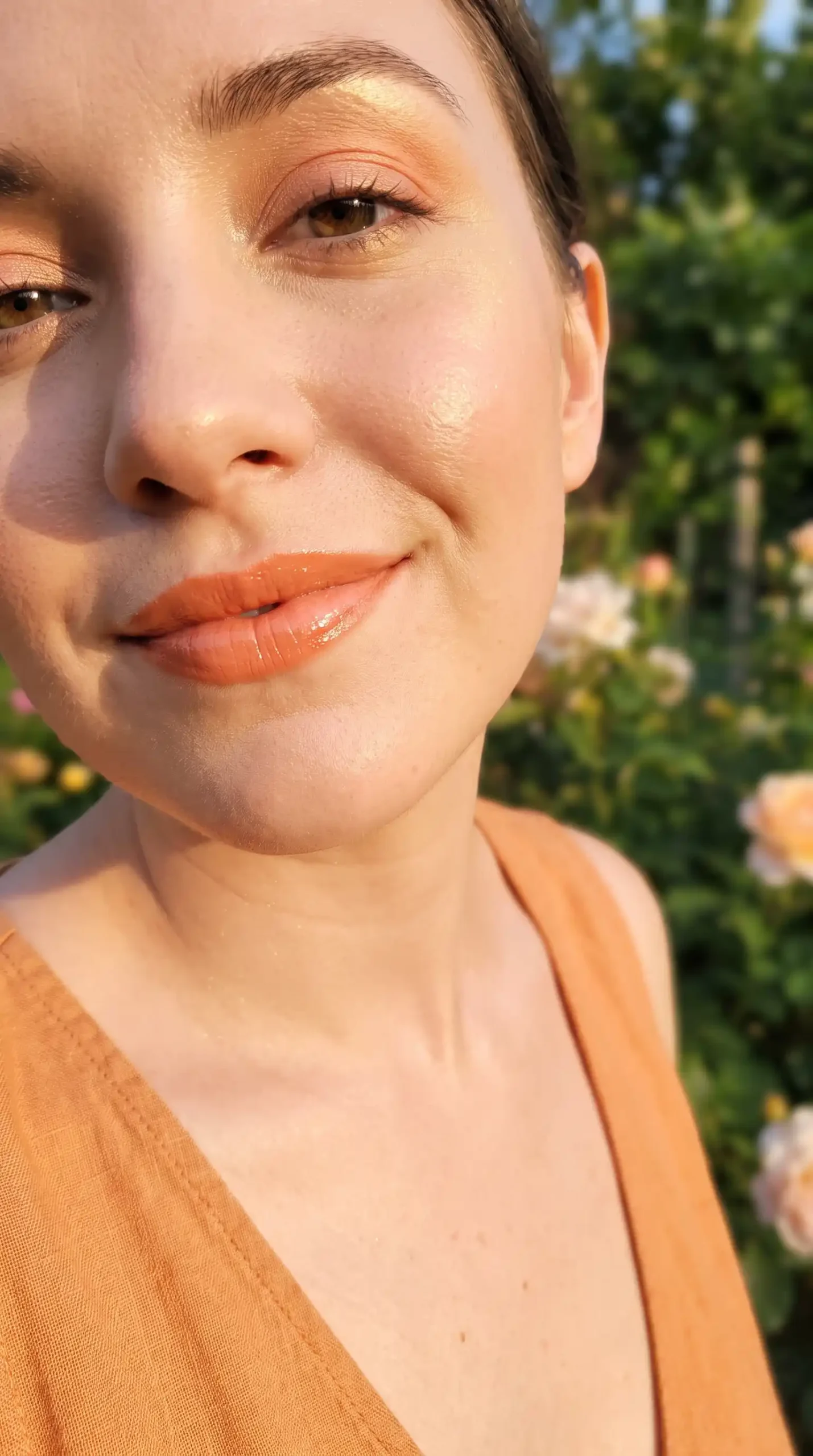 Woman wearing warm apricot soft orange glossy cream lipstick with fresh makeup